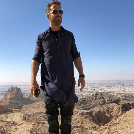 Ryan Reynolds' standing in a Hill.